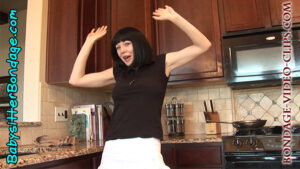 Babysitter Chloe Night Holding Her Hands Up Pretending She's Being Held Up for a Tie-Up Game